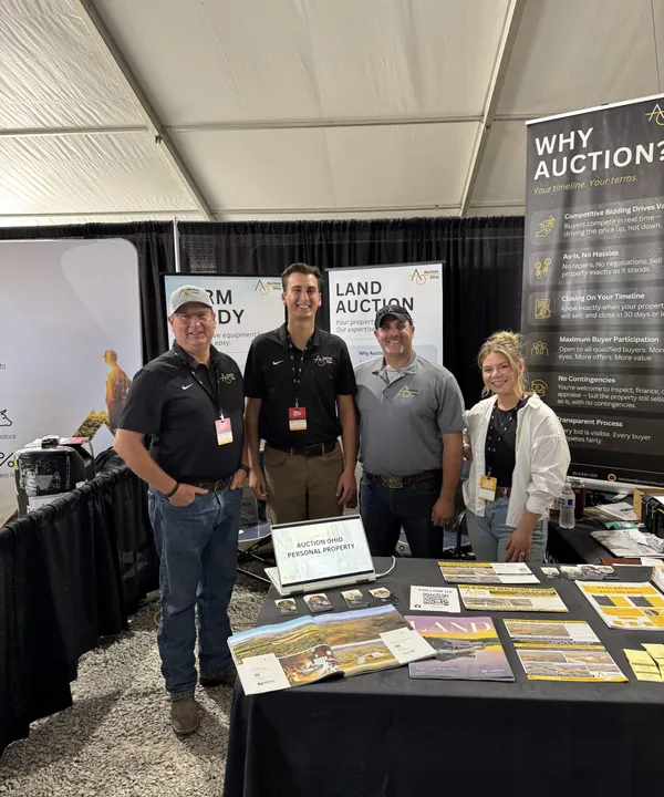 Team staff at a farm auction booth.